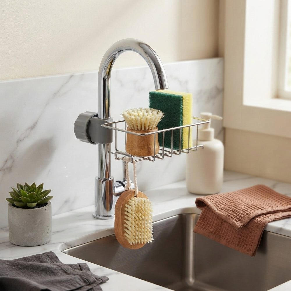A sink caddy organizer holding a sponge and brush on a clean kitchen counter next to a sink, showcasing an organized workspac